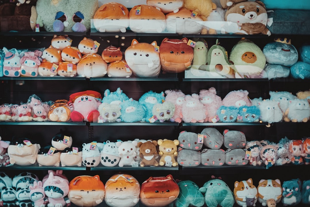 Colorful animal plush toys arranged on store shelves.